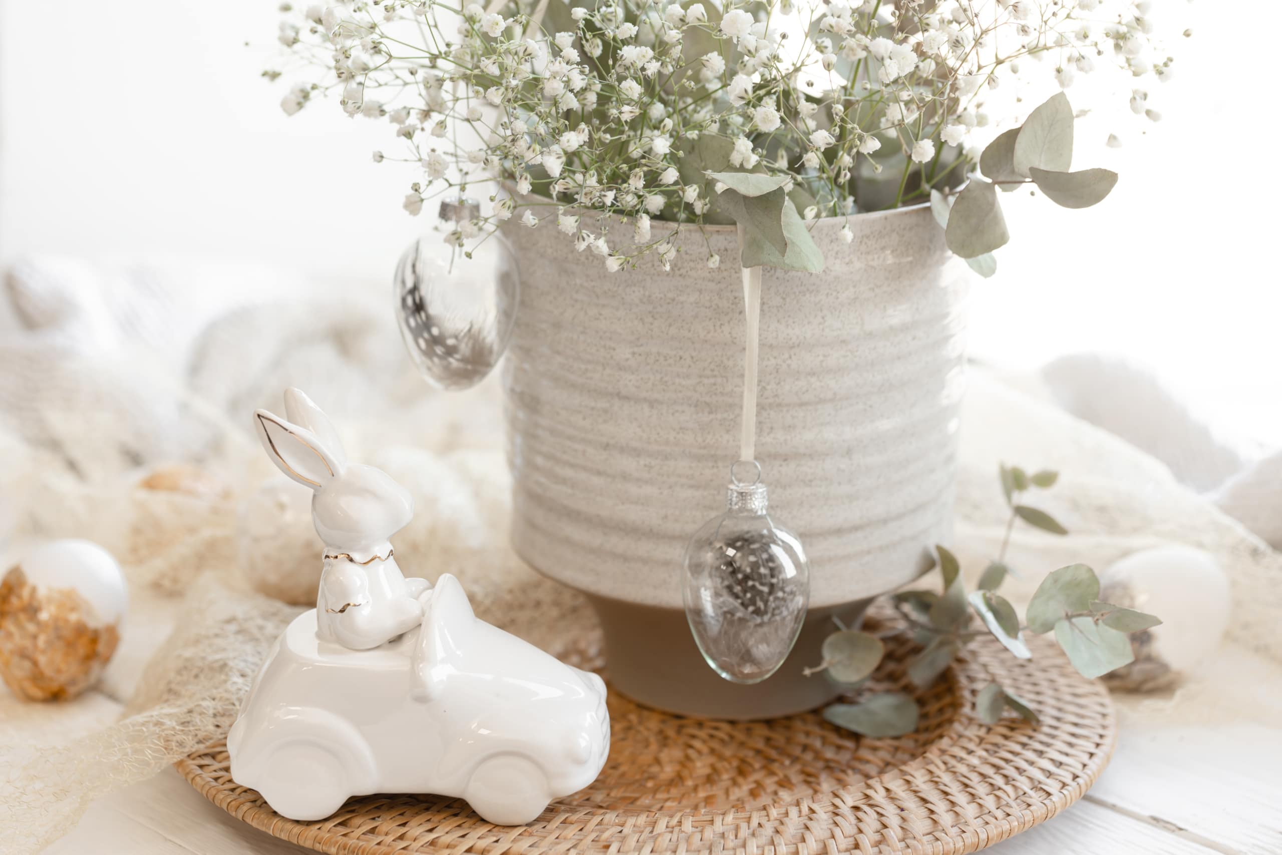 Easter composition with a ceramic hare and gypsophila flowers.